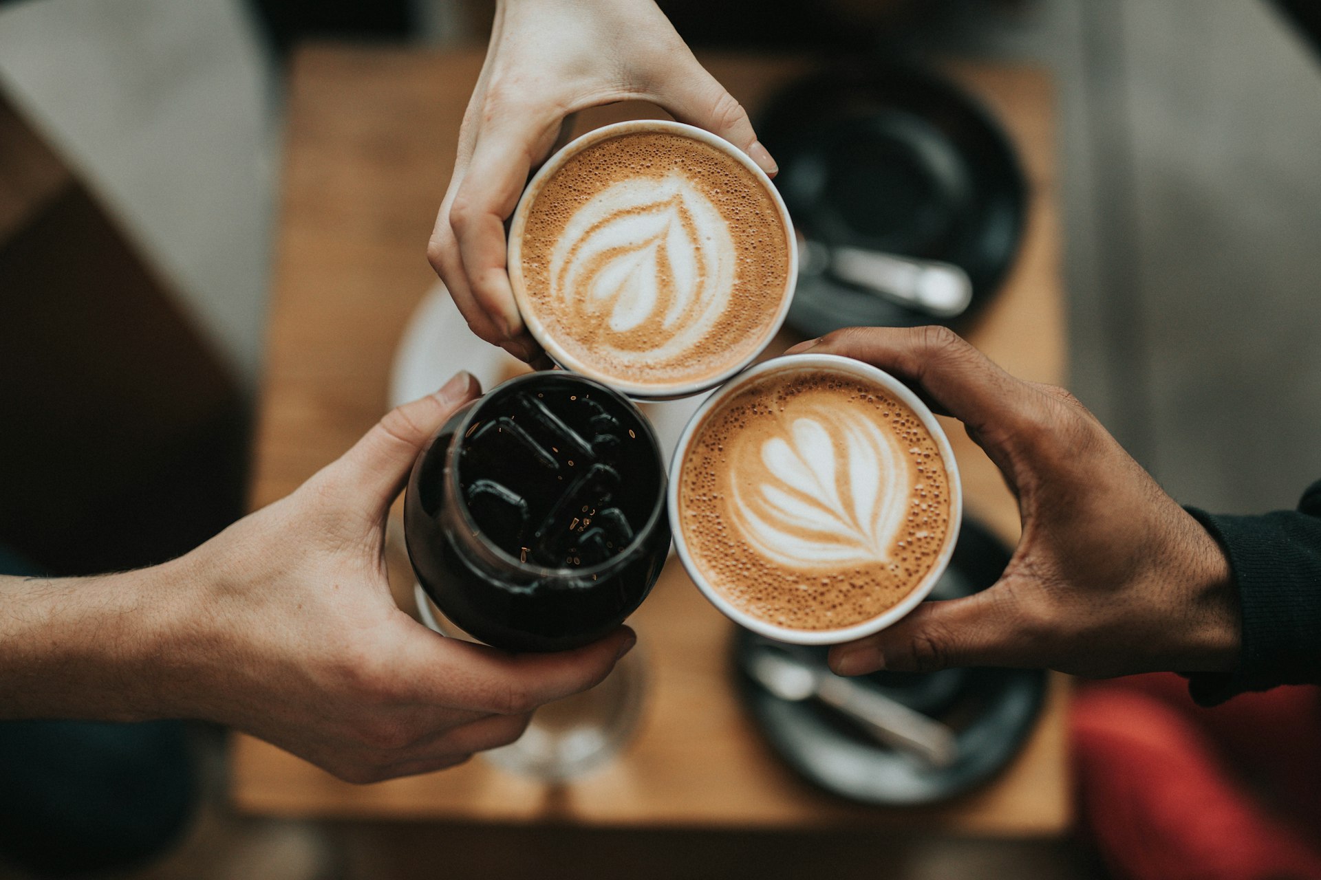 Freshly brewed coffee cups on a warm wooden table
